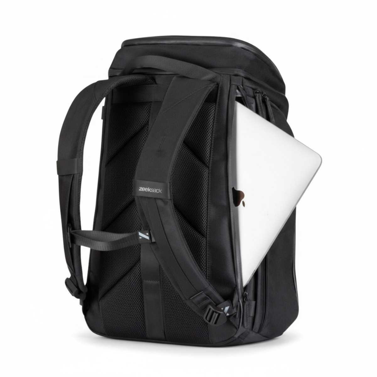 Svart ryggsäck med en silvrig laptop delvis inskjuten i sidofacket.